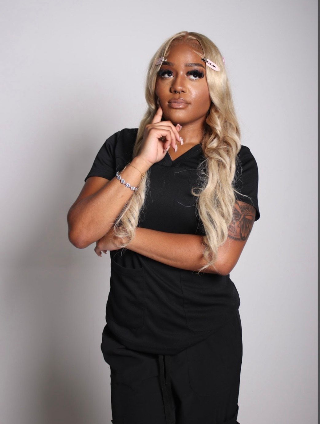 A plus size model is wearing a black bikini top and bottom