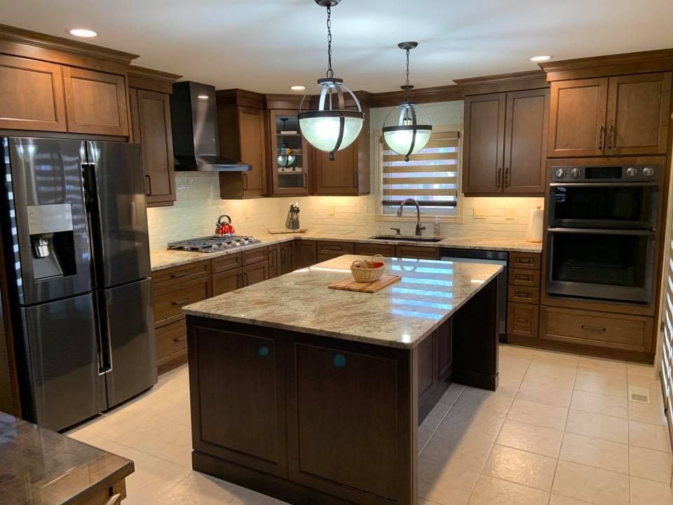A kitchen with a large island and stainless steel appliances.