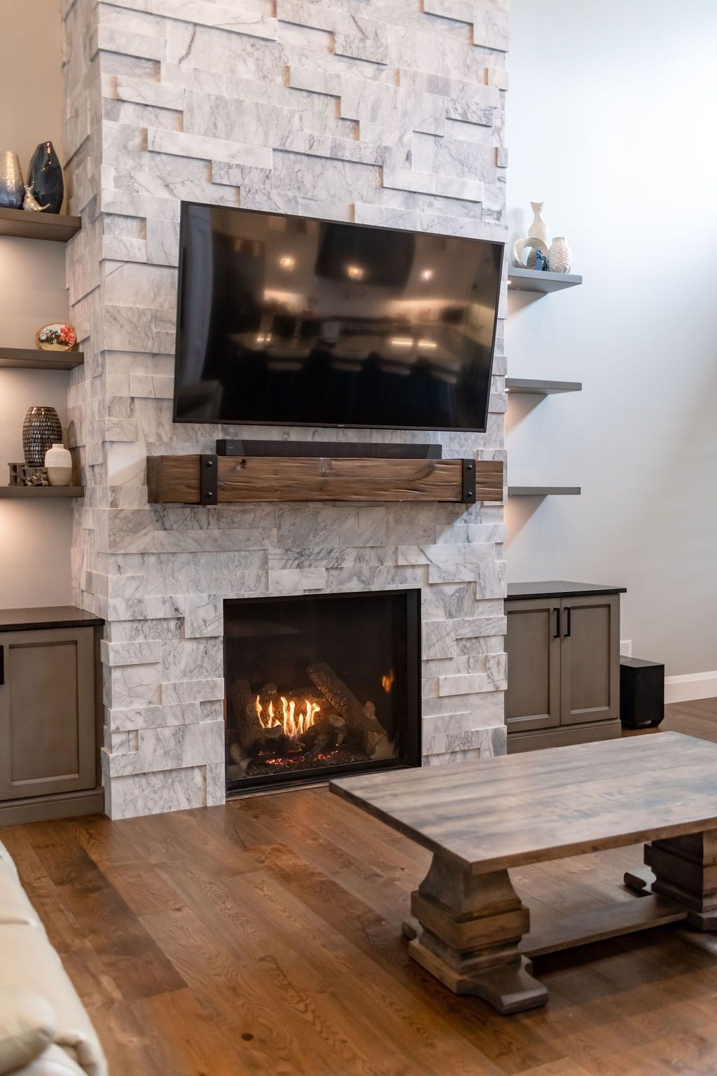 A living room with a fireplace and a flat screen tv.