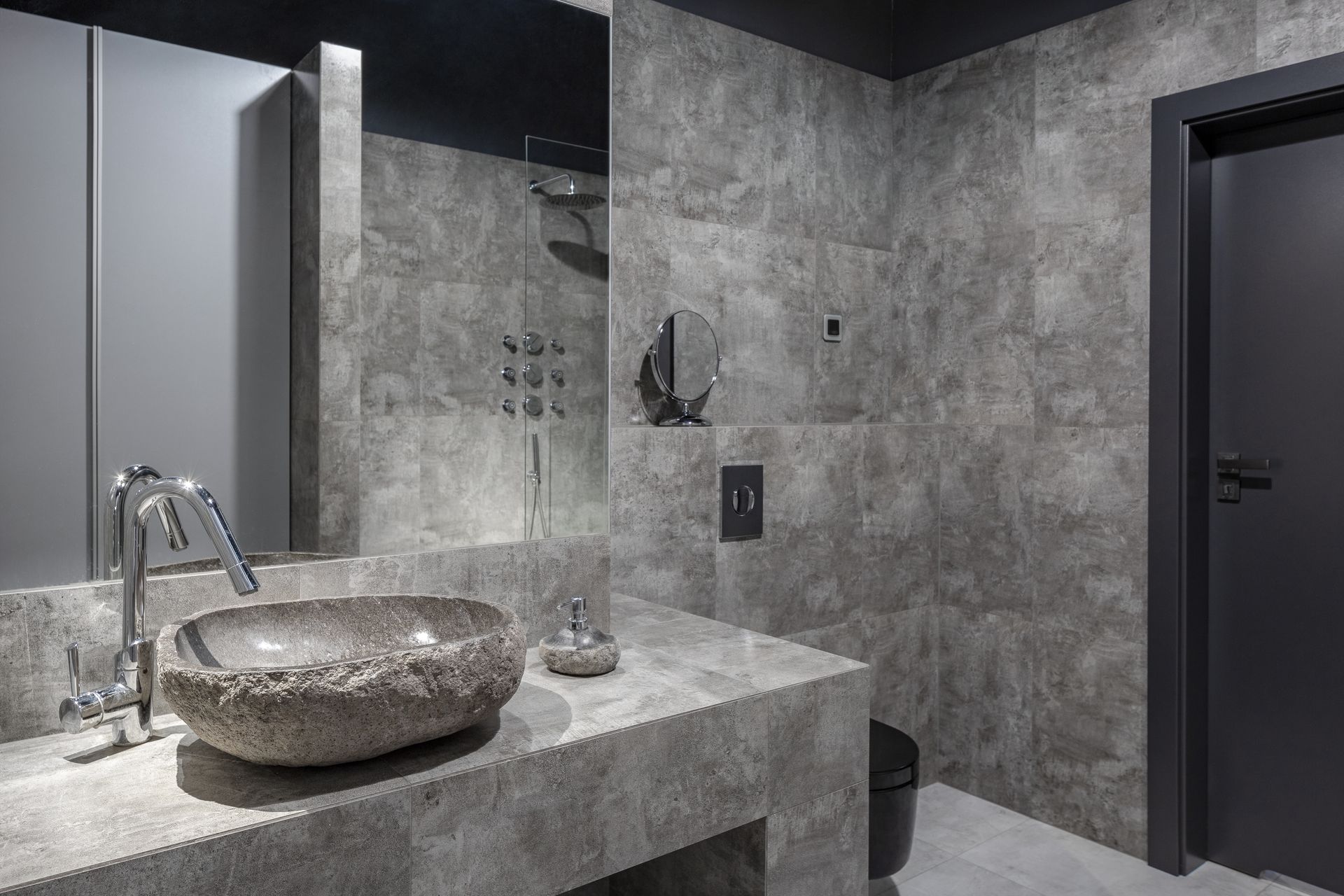 A bathroom with a sink , mirror , and toilet.