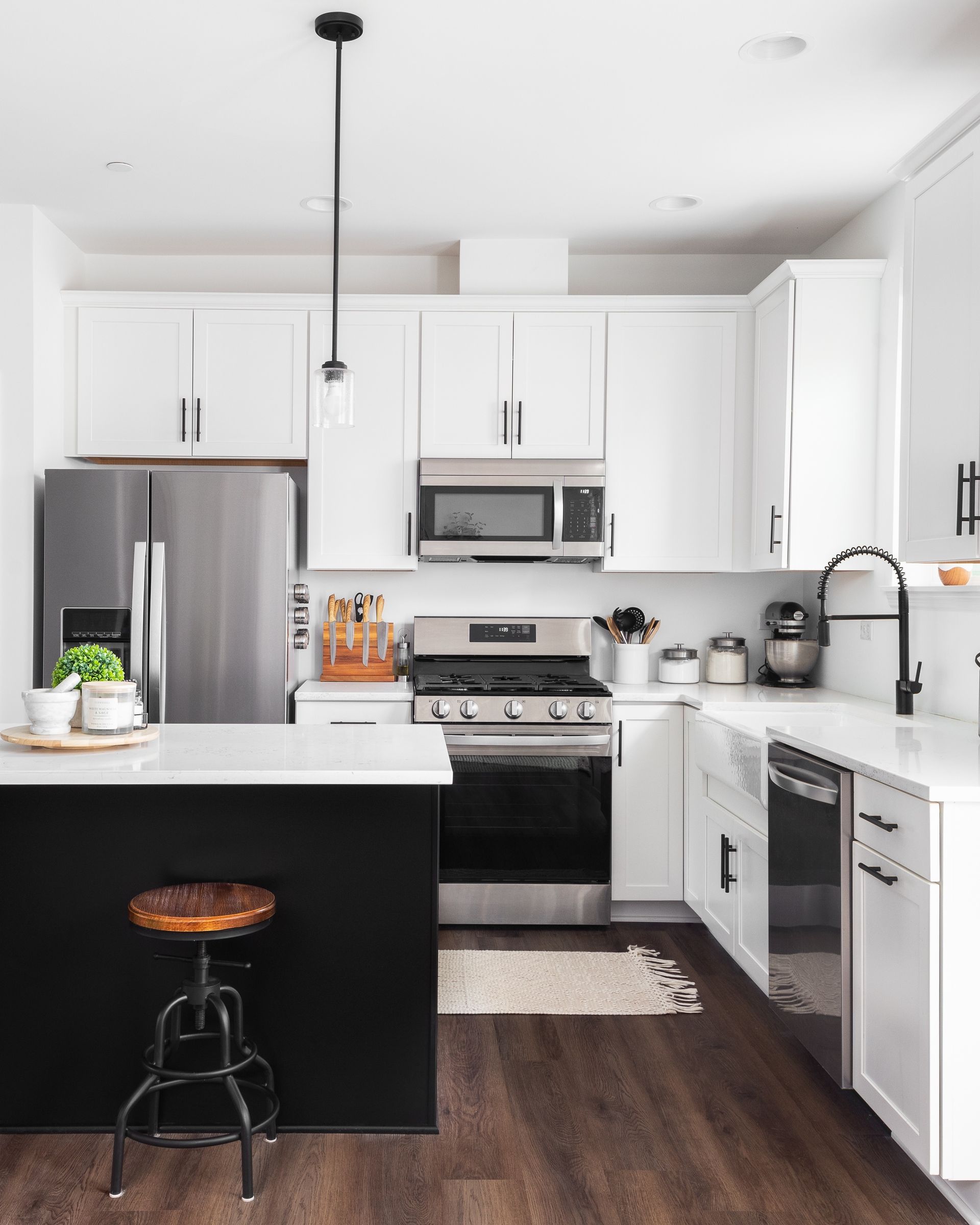 A kitchen with white cabinets and stainless steel appliances