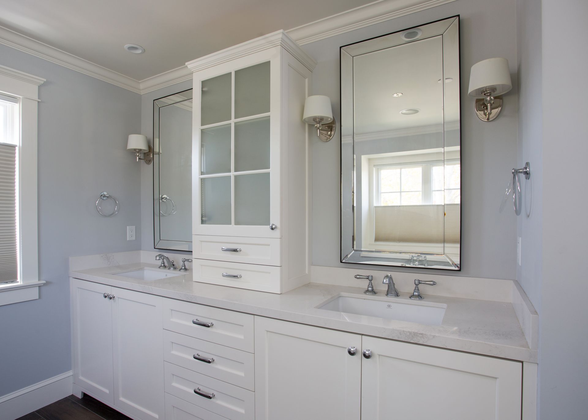 A bathroom with two sinks and two mirrors