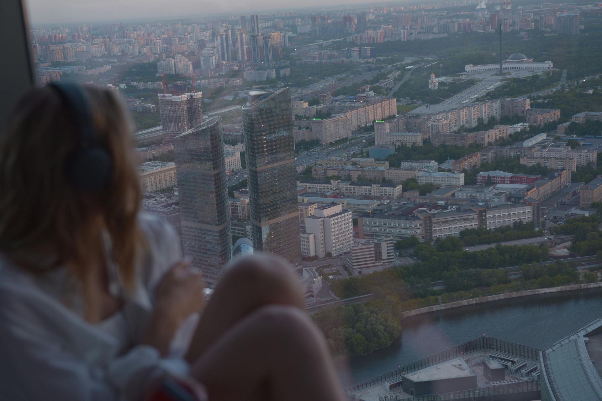 woman looking out of hotel window looking down on branson mo