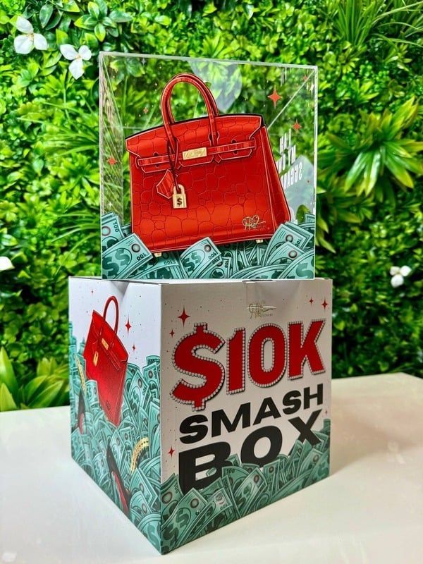 A red handbag is sitting on top of a box filled with money.
