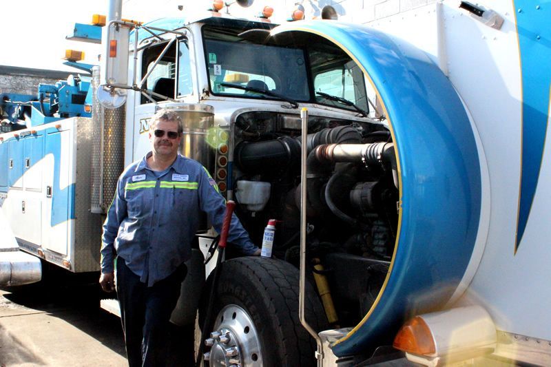 Arthur from Wallington Truck Repair standing proudly beside a heavy-duty service truck in Wallington, NJ.