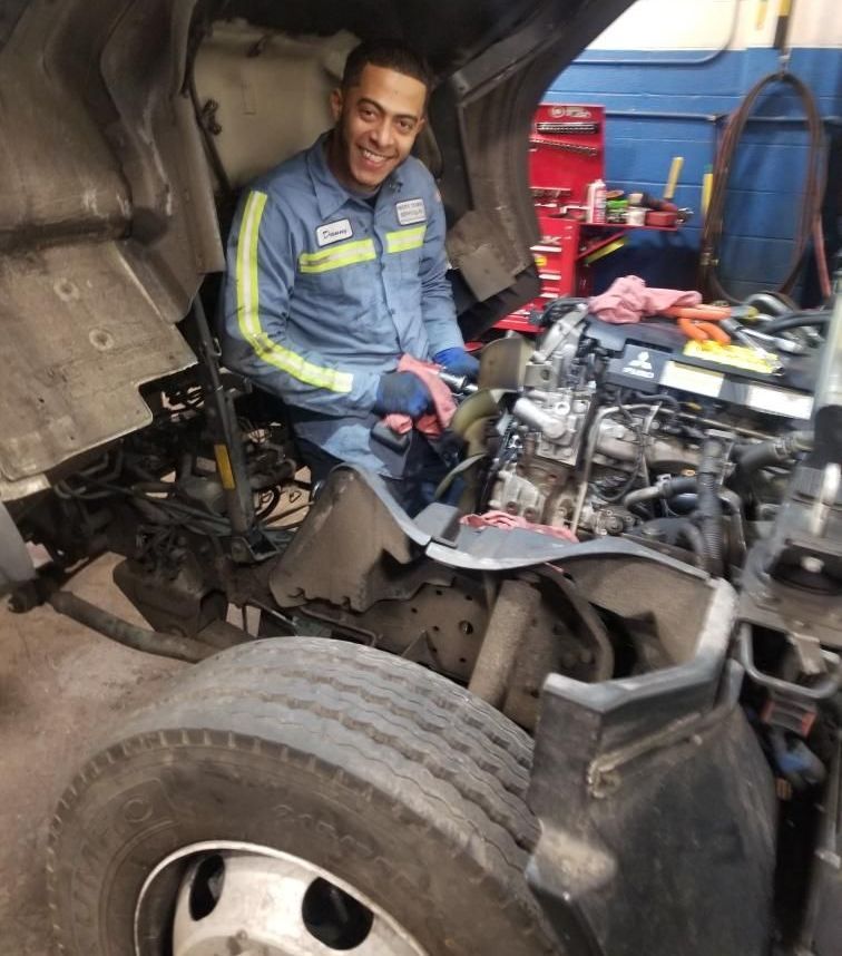 Danny Pujlos repairing a truck engine inside Wallington Truck Repair’s Bergen County facility.