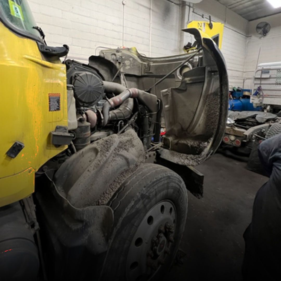 Preventative maintenance work on yellow commercial truck in Bergen County, near Lyndhurst NJ.