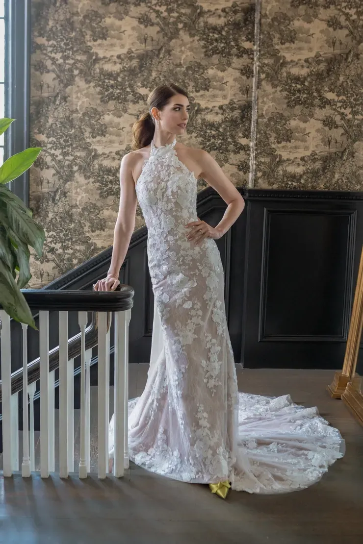 A woman in a wedding dress is standing on a staircase.
