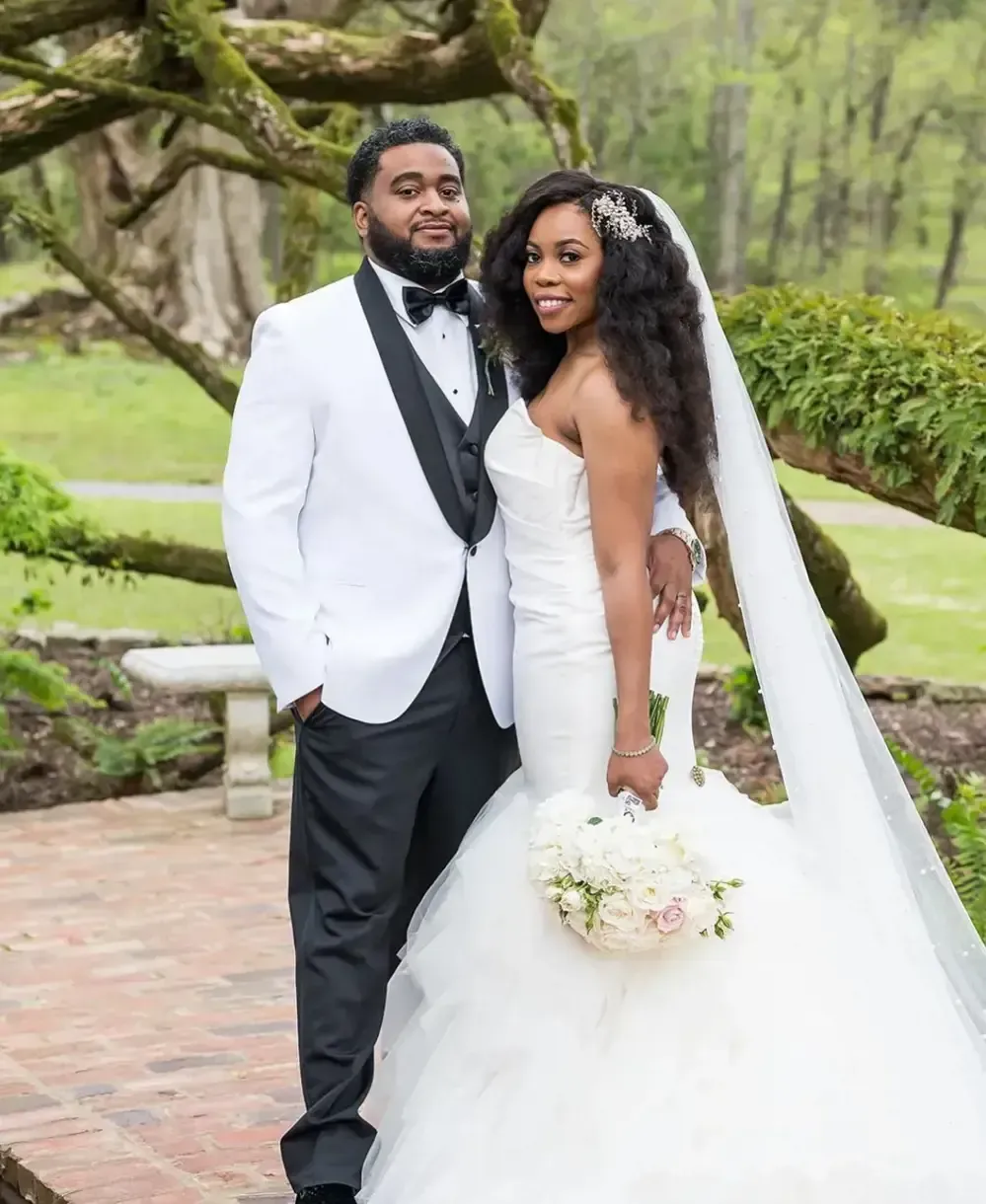 A bride and groom are posing for a picture on their wedding day.