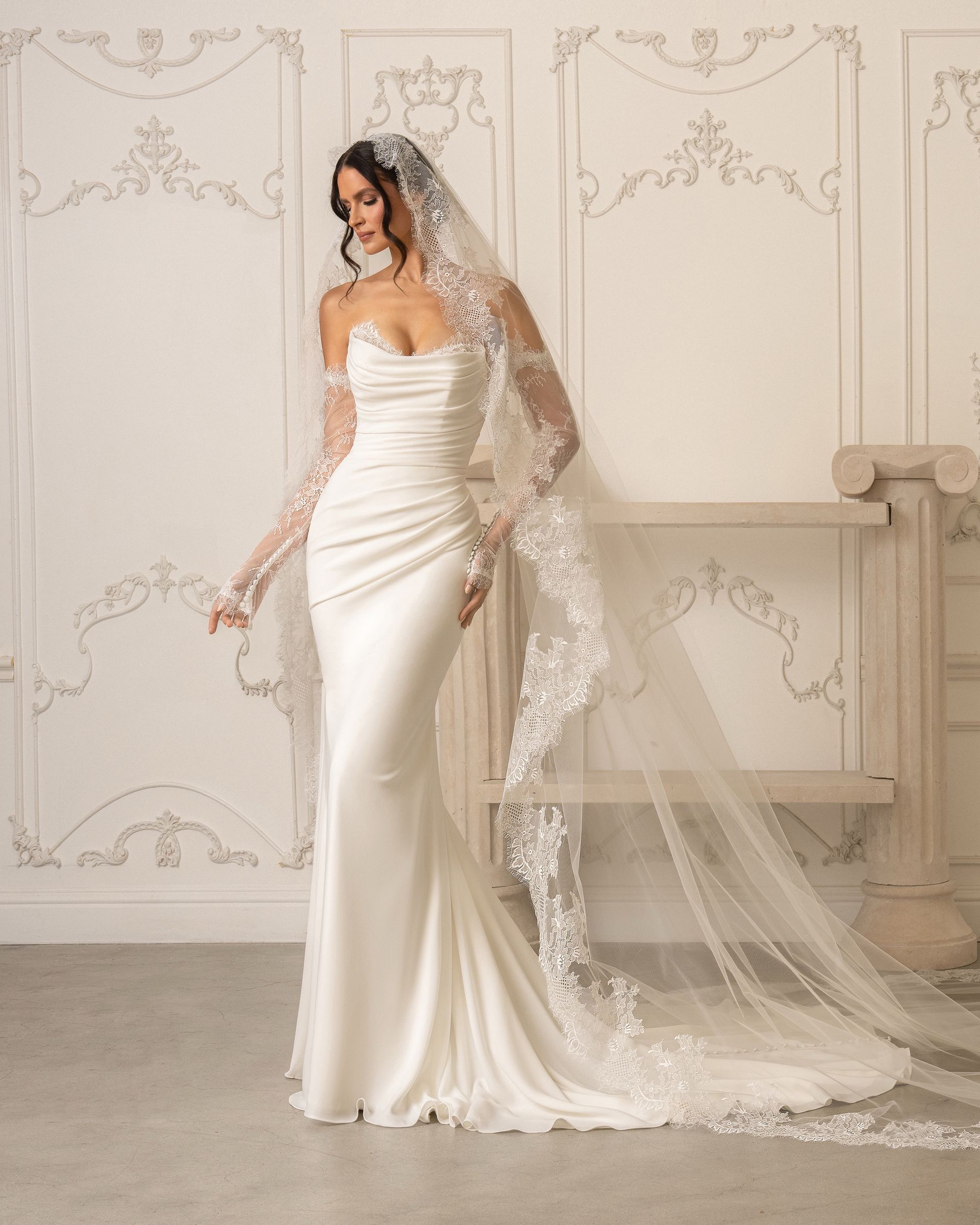 A woman is wearing a white wedding dress with a high slit.