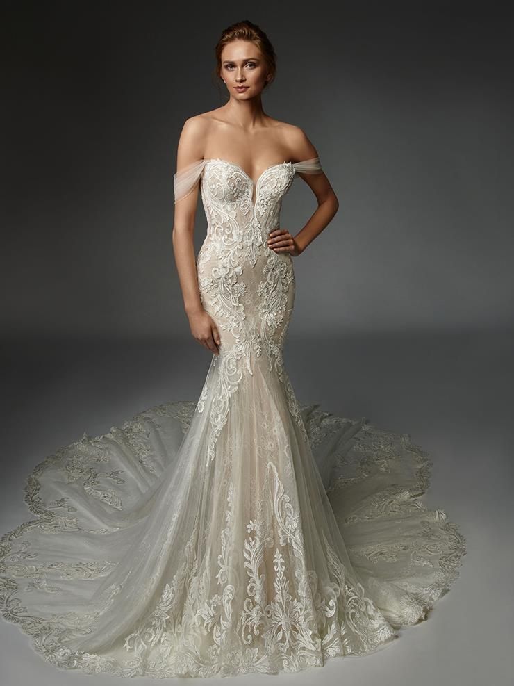 A woman is wearing a white wedding dress with a long train.