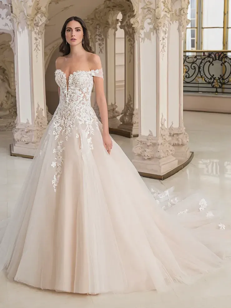 A woman in a wedding dress is standing in front of a building.