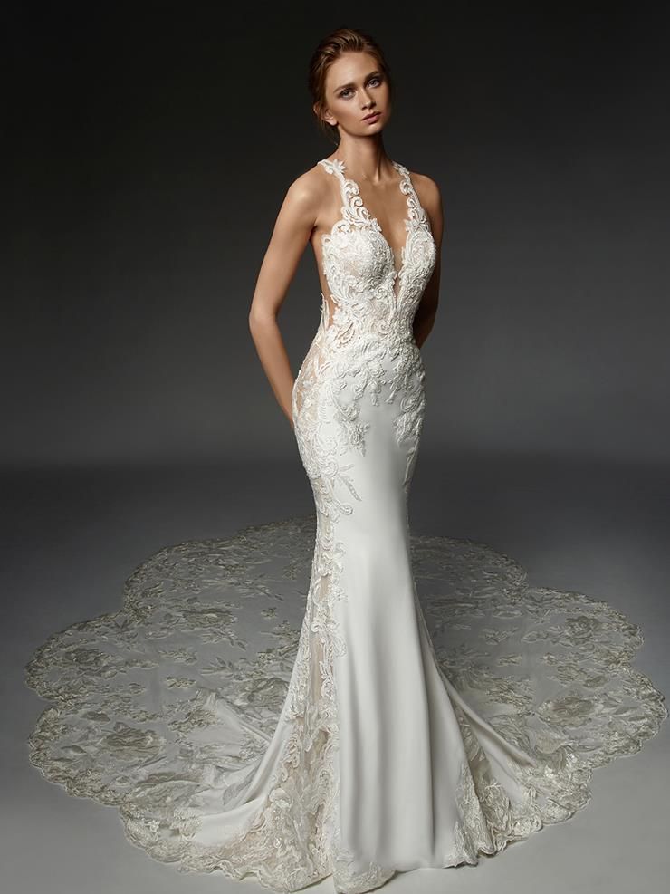 A woman is wearing a white wedding dress with a long train.