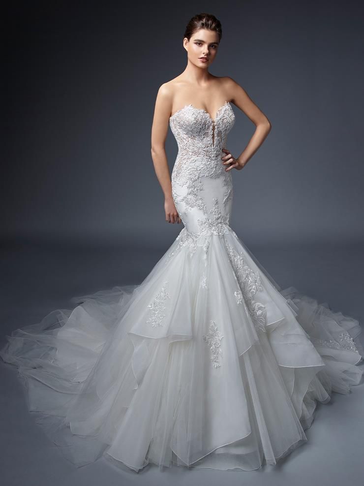A woman is wearing a white wedding dress with a long train.
