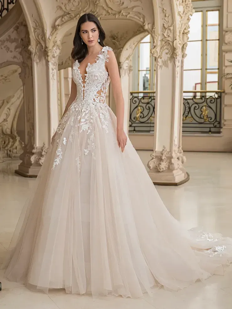 A woman is wearing a white wedding dress in a room.