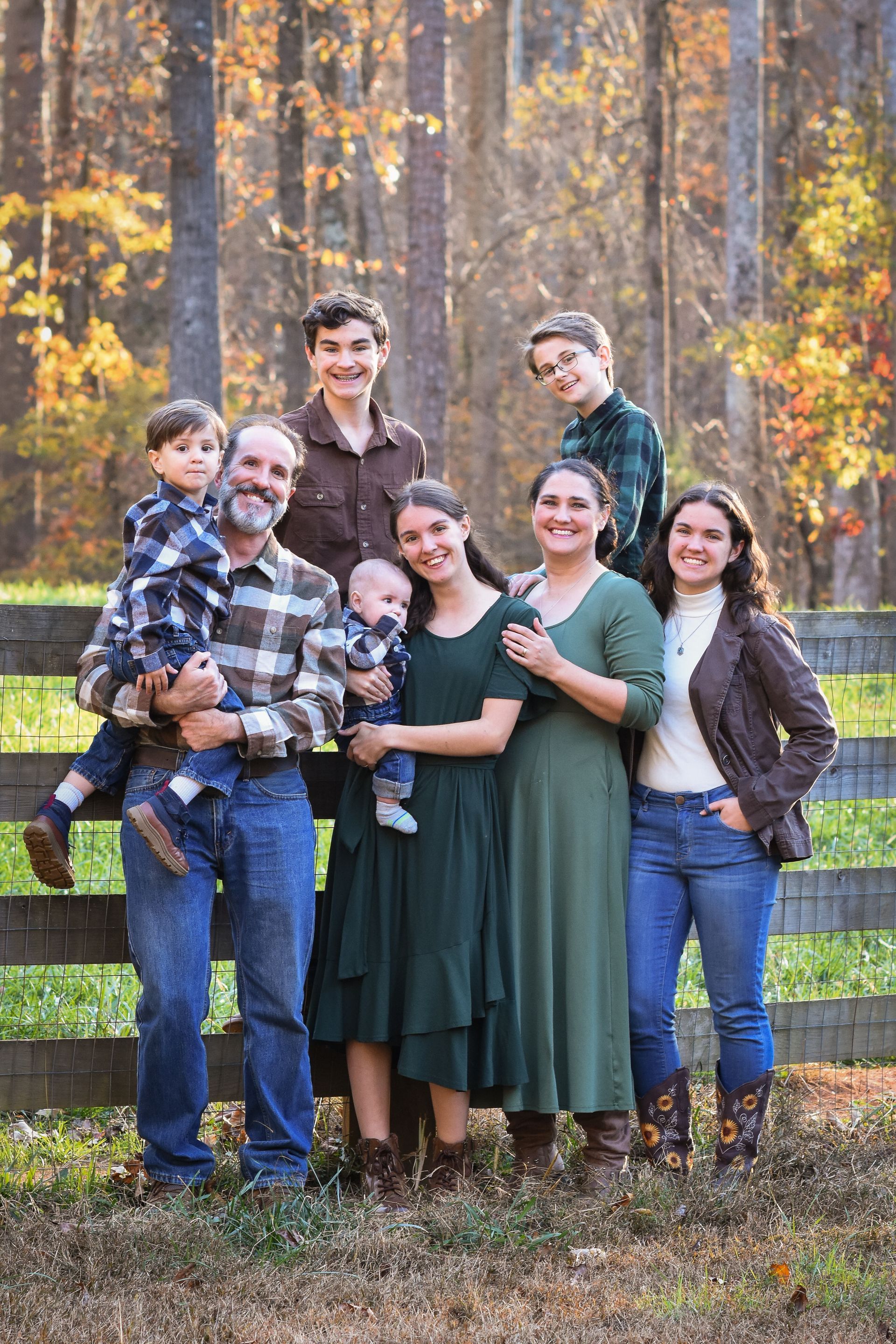 A family is posing for a picture in a field.