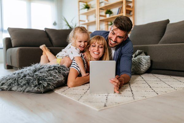 A Happy Family Looking on a Tablet — Boone NC — Boone Heating & Air Conditioning Inc