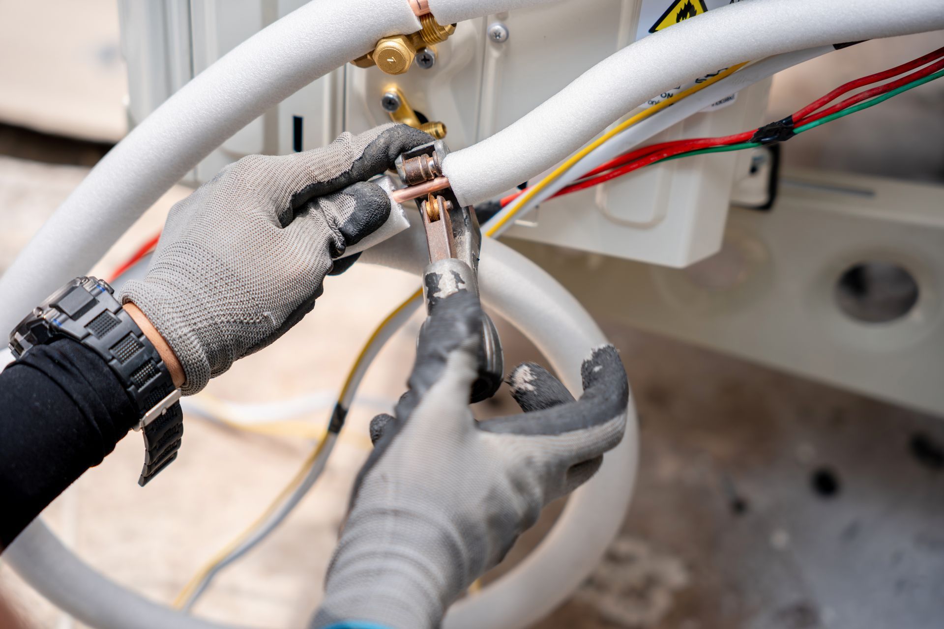 Close-up of a local heating contractor performing expert maintenance on exterior climate equipment.