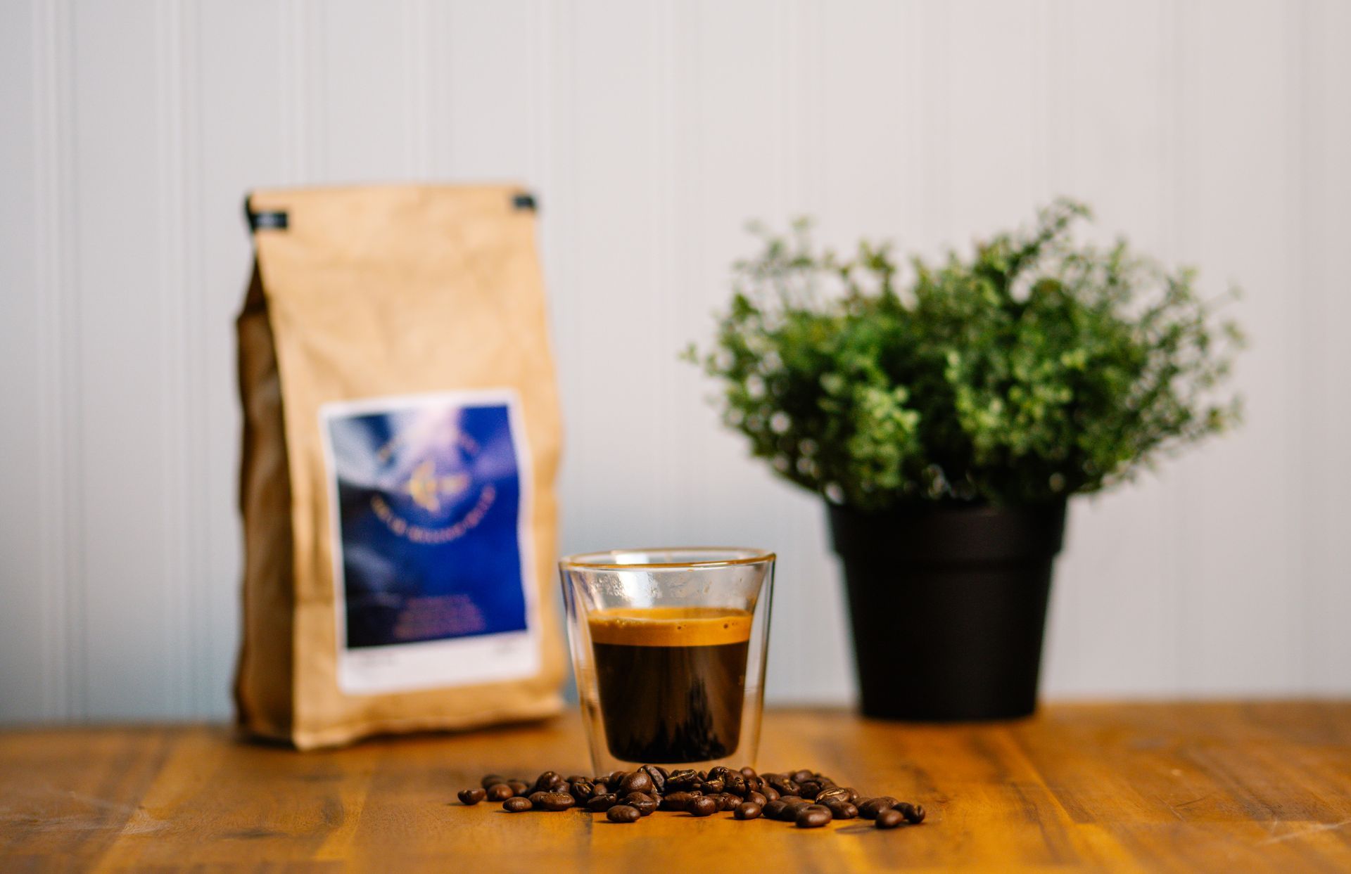A bag of coffee next to a cup of coffee