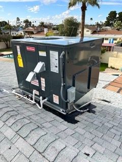A large box is sitting on top of a roof.