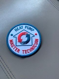 A patch that says heat pump master technician on it