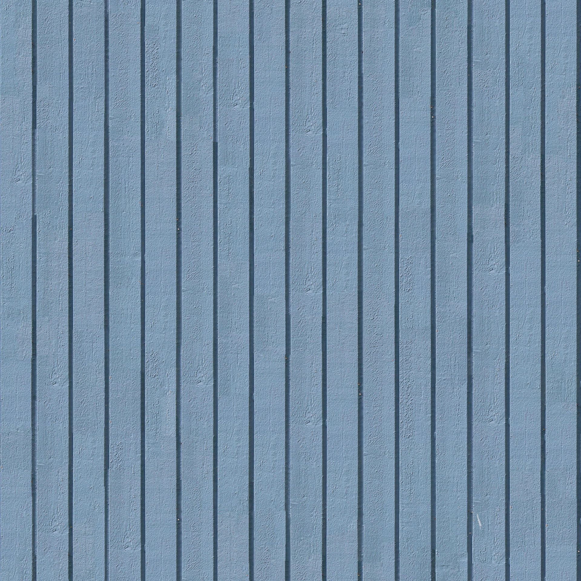 Blue corrugated metal paneling. Vertical lines create shadows.