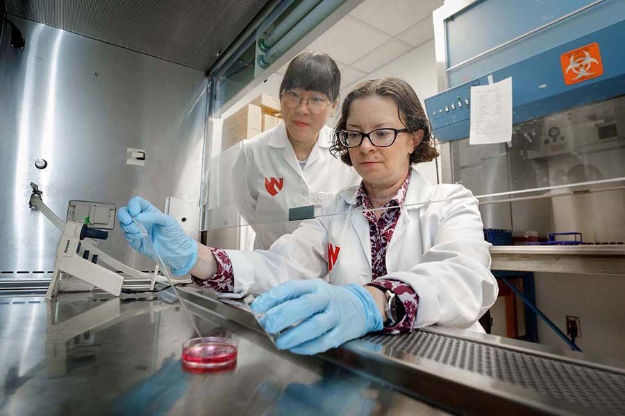Sign for UNMC Nebraska Medicine with buildings in background; sunny day.