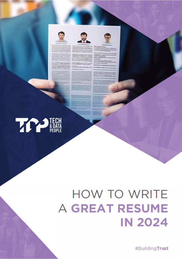 A man in a suit is holding a resume in his hands.