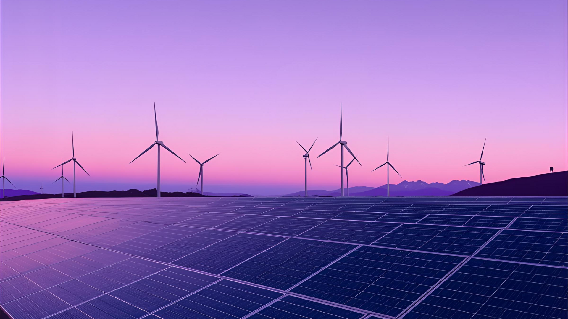Wind turbines and solar panels under a pink and purple sunset sky.