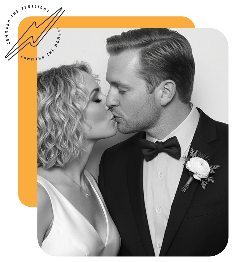 Bride and groom kissing, black and white photo. He wears a tuxedo, she wears a dress.  Yellow frame.