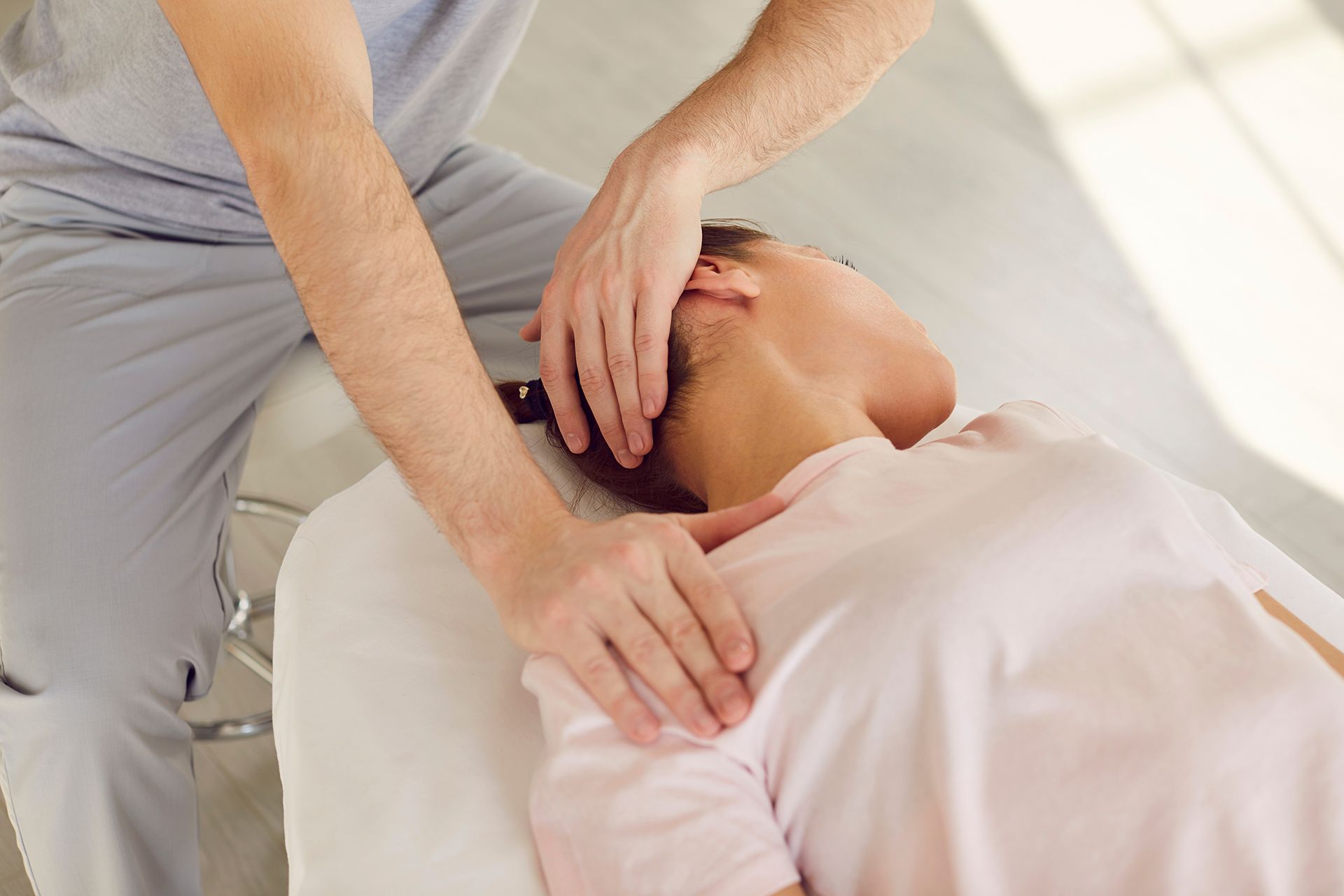 A man is giving a woman a massage on a table.