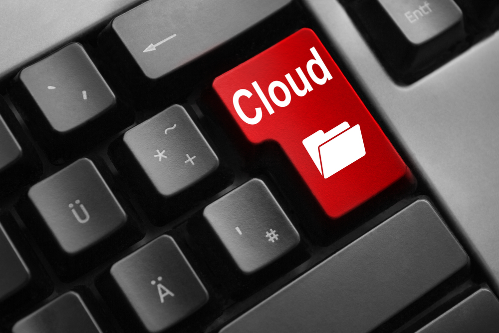 A computer keyboard with a red button that says cloud