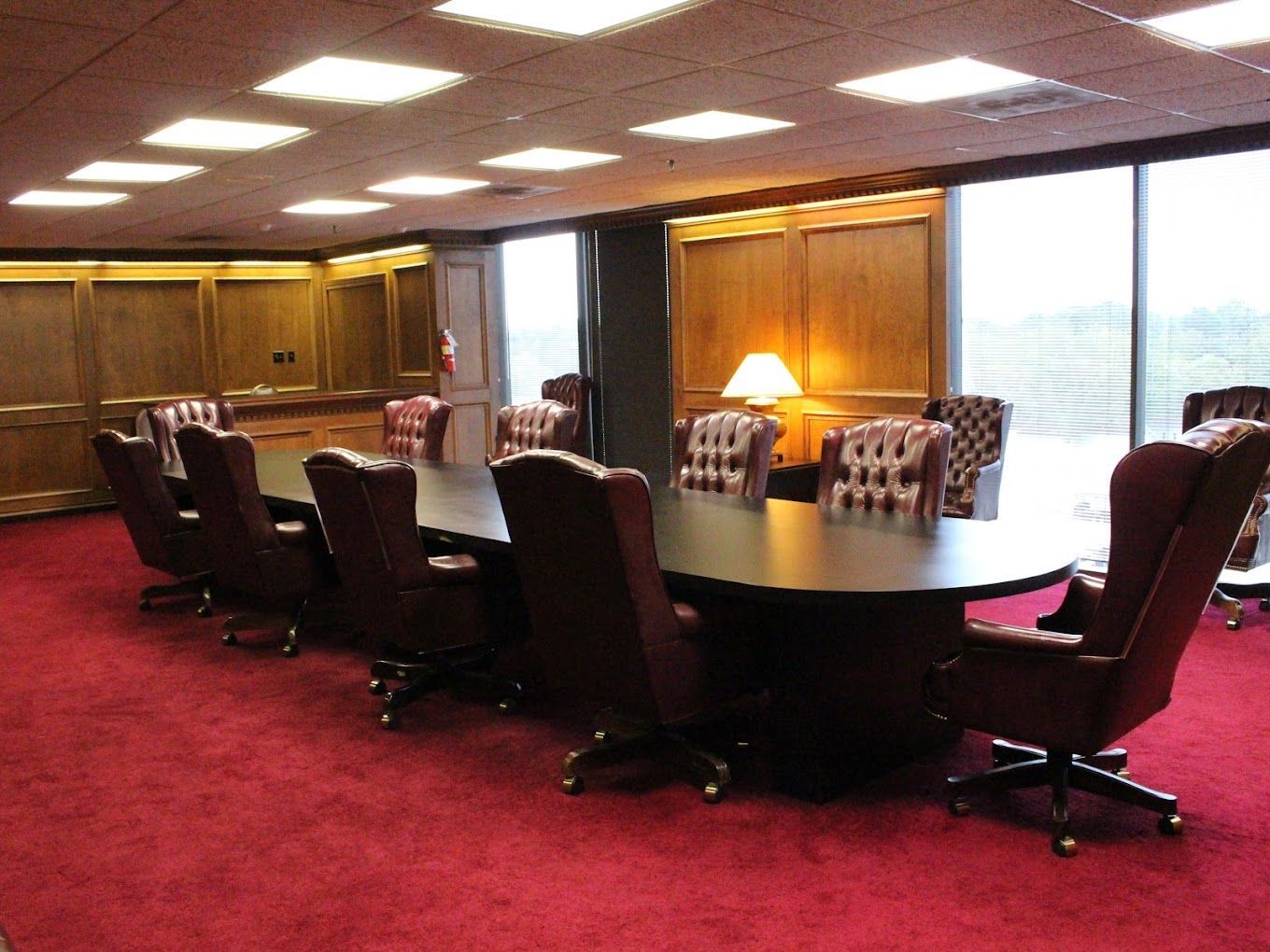 A conference room with a long table and chairs