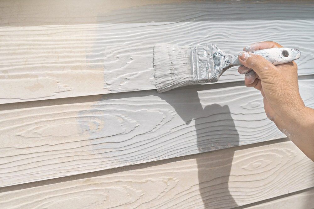 A Person is Painting a Wooden Wall With a Brush — Prota NT in Howard Springs, NT