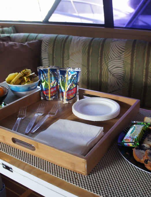 A wooden tray with plates and utensils on it