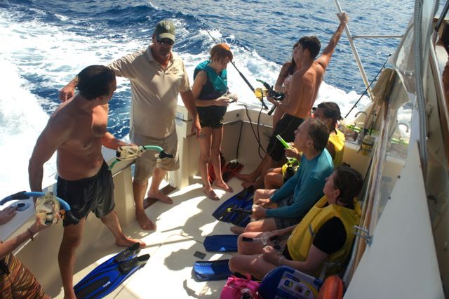 A group of people are on a boat in the ocean