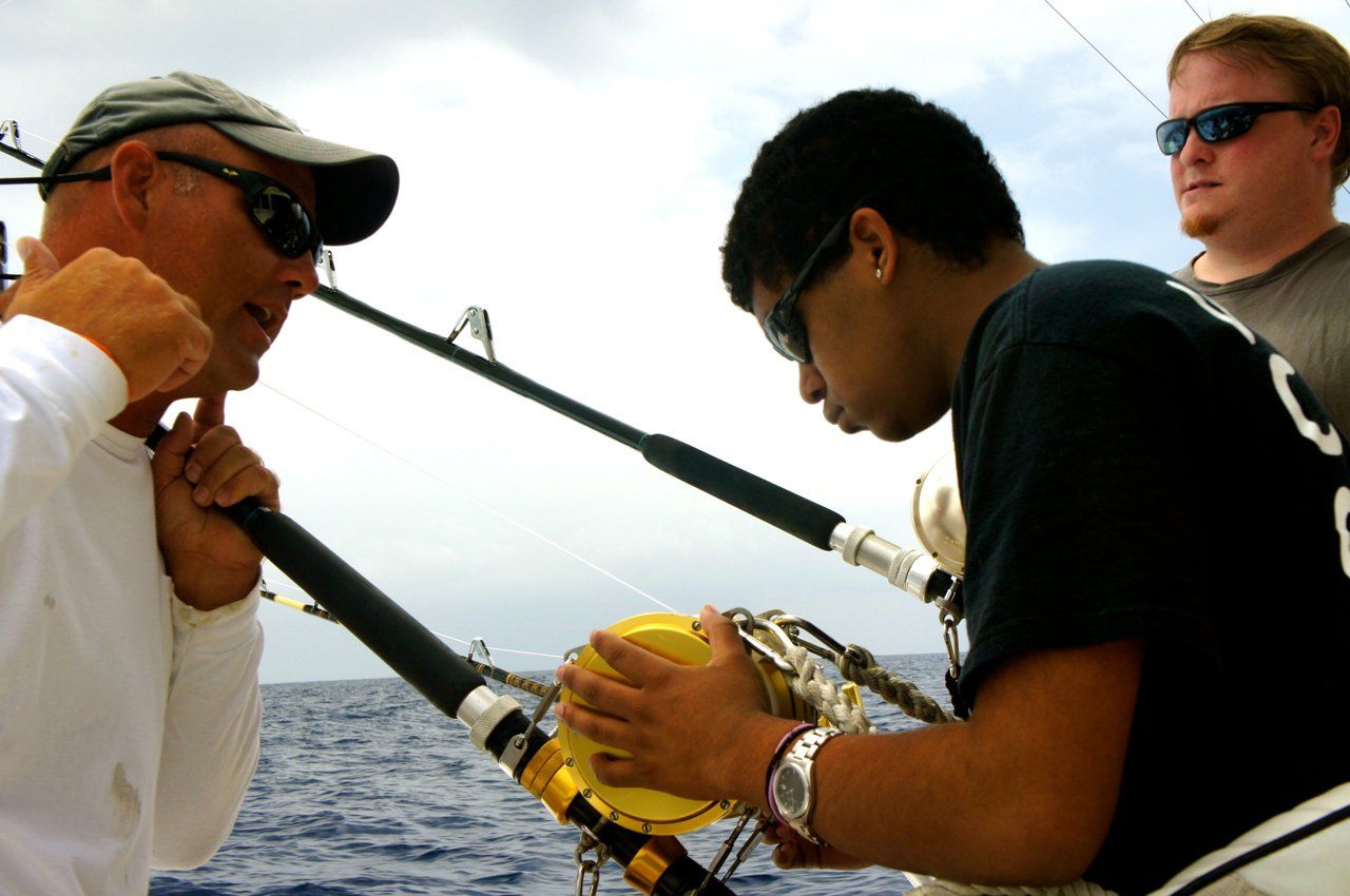 A man with the number 8 on his shirt is fishing
