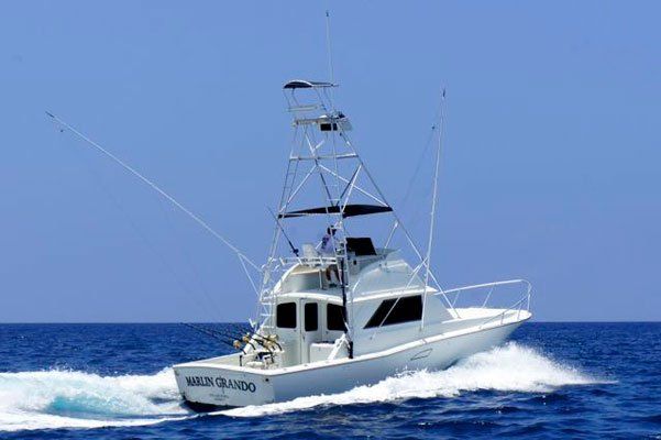 A large white boat is floating on top of a large body of water.