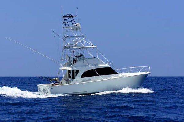 A large white boat is floating on top of a large body of water.