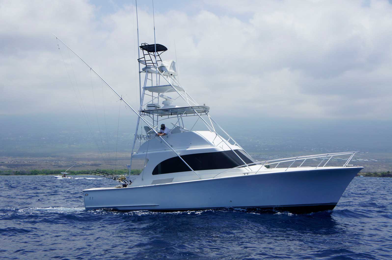 A large white boat is floating on top of a body of water.