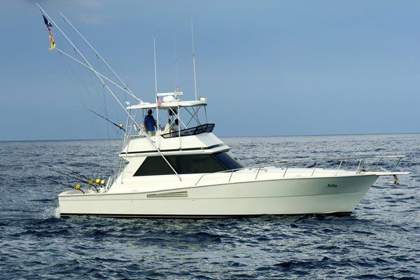 A large white boat is floating on top of a large body of water.