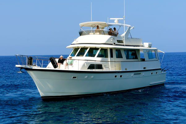 A large white boat is floating on top of a large body of water.