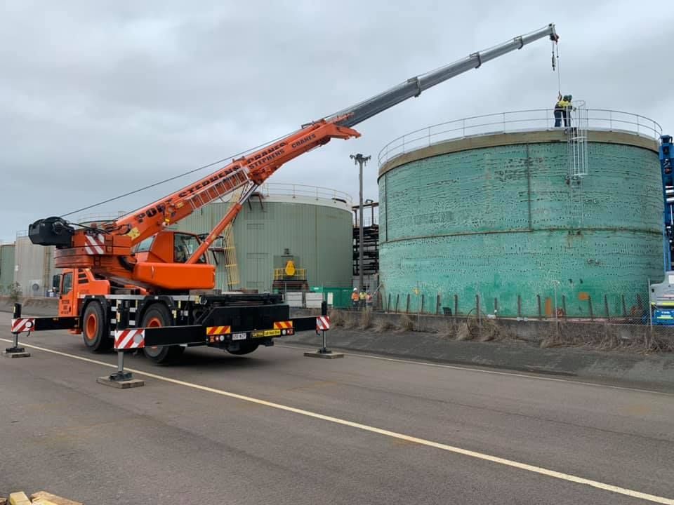 Two Yellow And Blue Aerial Lifts Are Against A Blue Sky With Clouds — Port Stephens Cranes In Newcastle, NSW