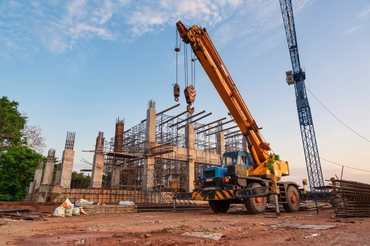 A Construction Site With A Crane And A Building Under Construction — Port Stephens Cranes In Lake Macquarie, NSW
