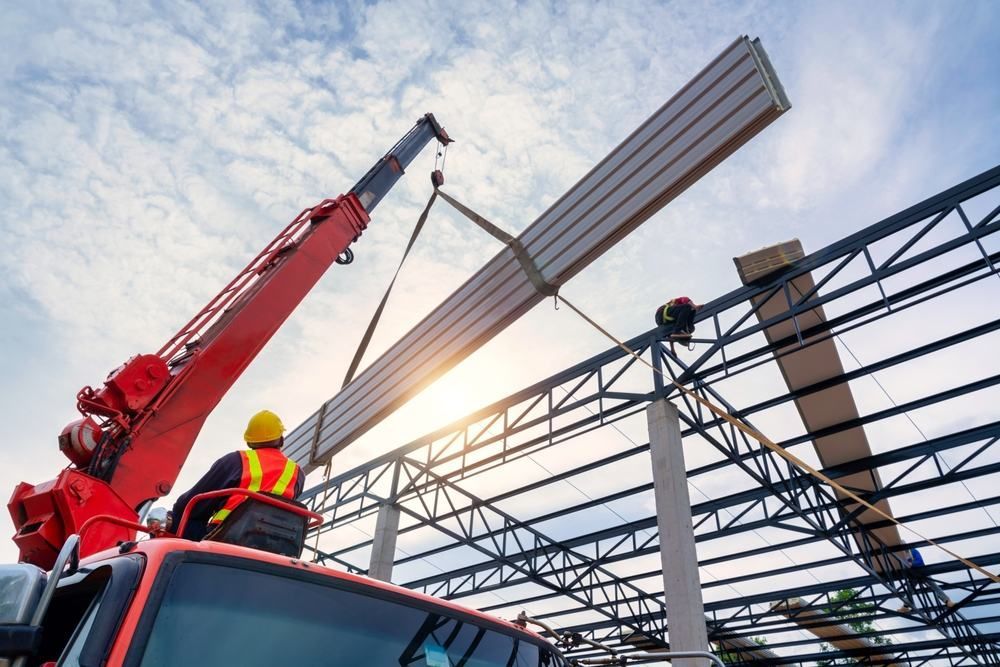 Sitting On Top Of A Truck While A Crane Lifts A Piece Of Metal — Port Stephens Cranes In Newcastle, NSW