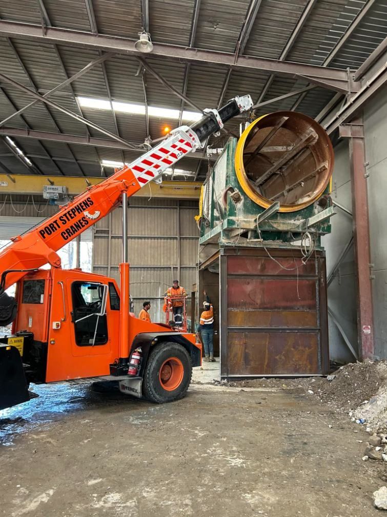 A Crane Is Lifting A Large Machine In A Warehouse — Port Stephens Cranes In Salt Ash, NSW