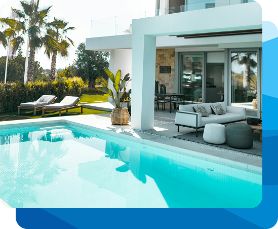 Woman in a blue bikini exiting a pool, smiling. Pool has a ladder, surrounded by greenery.