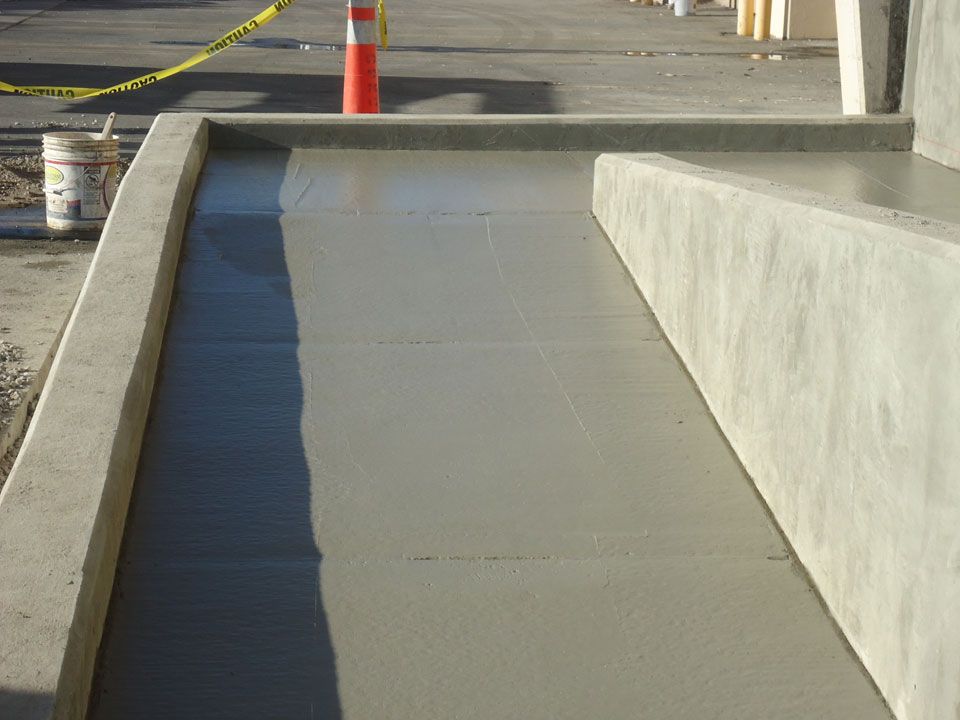 A concrete ramp is being built on the side of the road
