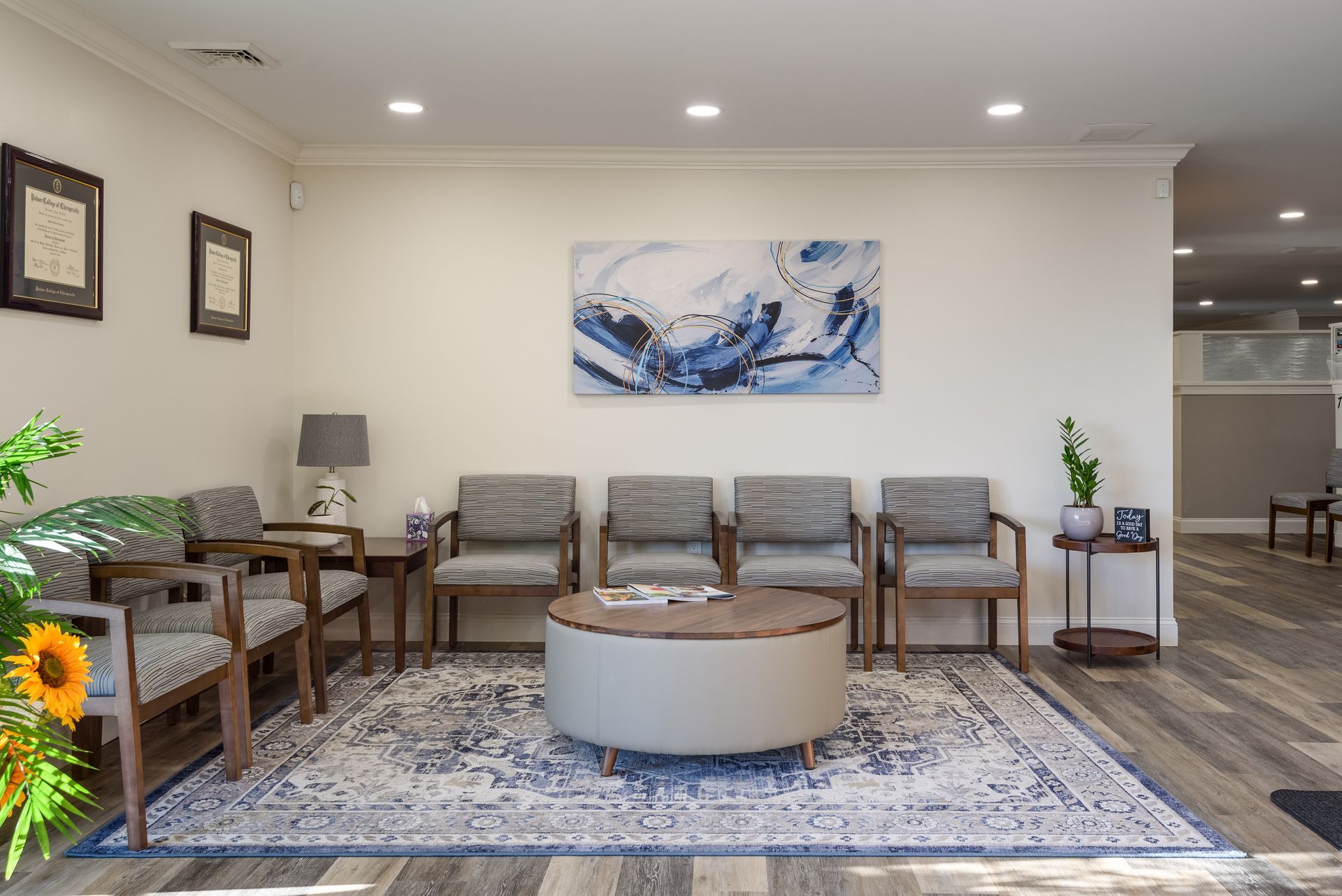 A long hallway with a row of chairs in it.