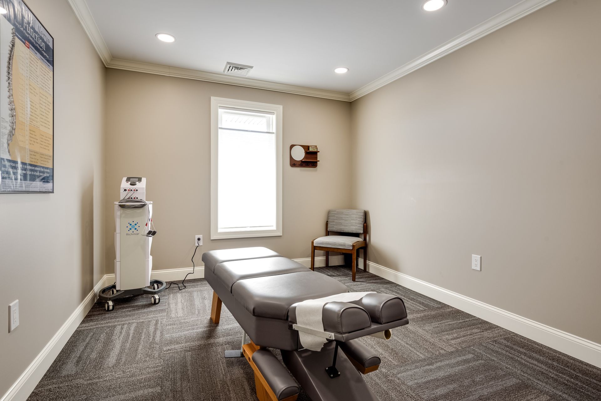 a room at back 2 health with a table and a chair and equipment in Tannersville, PA